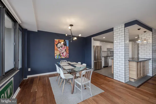 a view of a dining room with furniture and wooden floor
