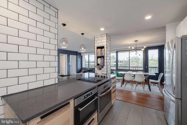 a kitchen with a sink and large window