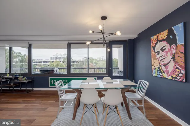a view of a dining room with furniture large windows and wooden floor