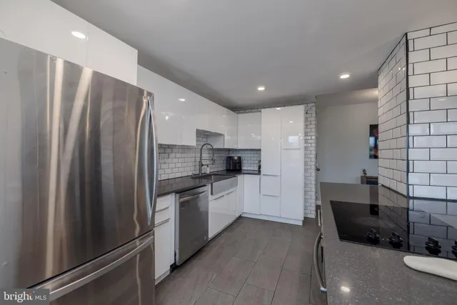 a kitchen with stainless steel appliances a refrigerator and a sink