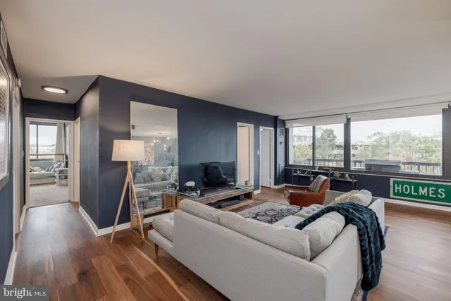 a living room with furniture and a floor to ceiling window