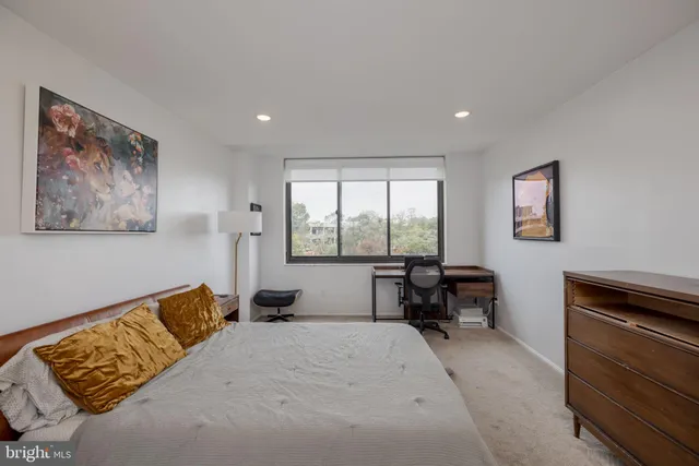 a large bedroom with a bed and furniture