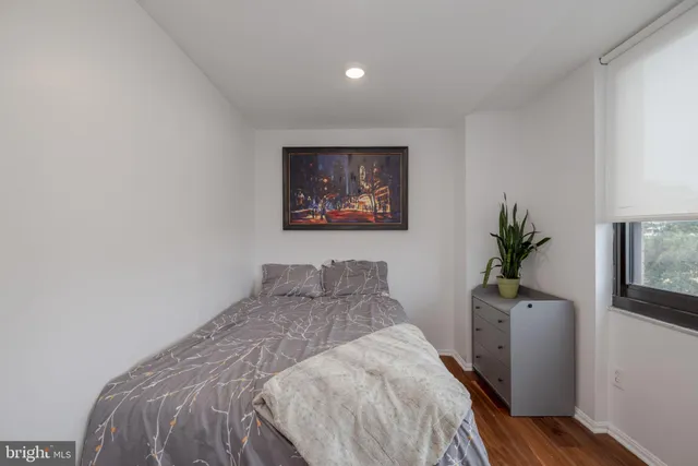 a bedroom with a bed and a potted plant