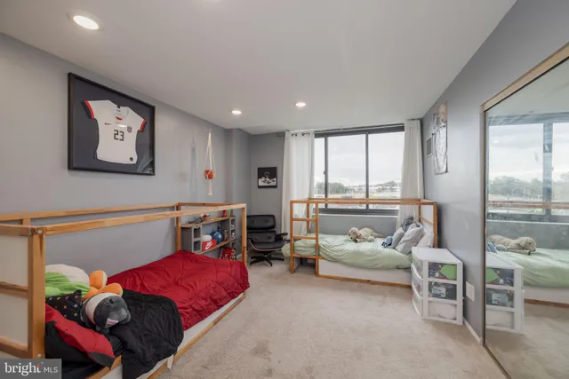 a bedroom with furniture and a large window