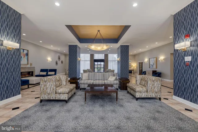 a living room with furniture and a chandelier