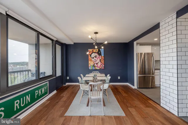 a dining room with furniture a chandelier and wooden floor