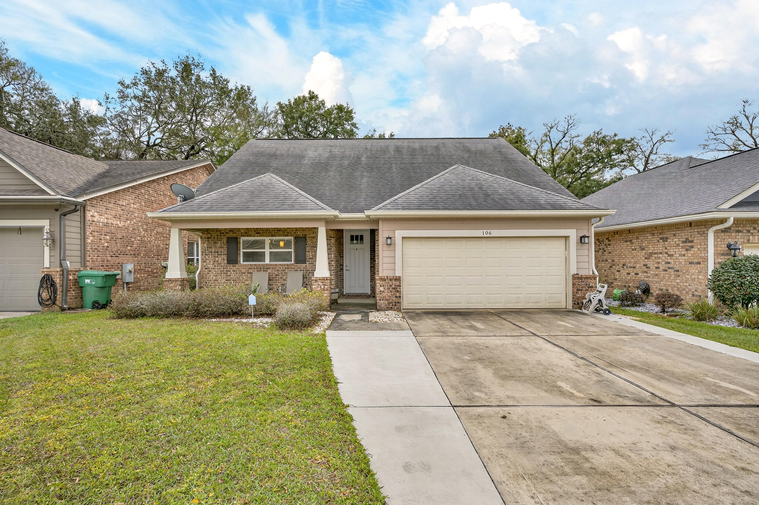 106 Arrowhead Way Niceville, FL 32578 - Photo 1 of 39 a front view of a house with a garden and yard
