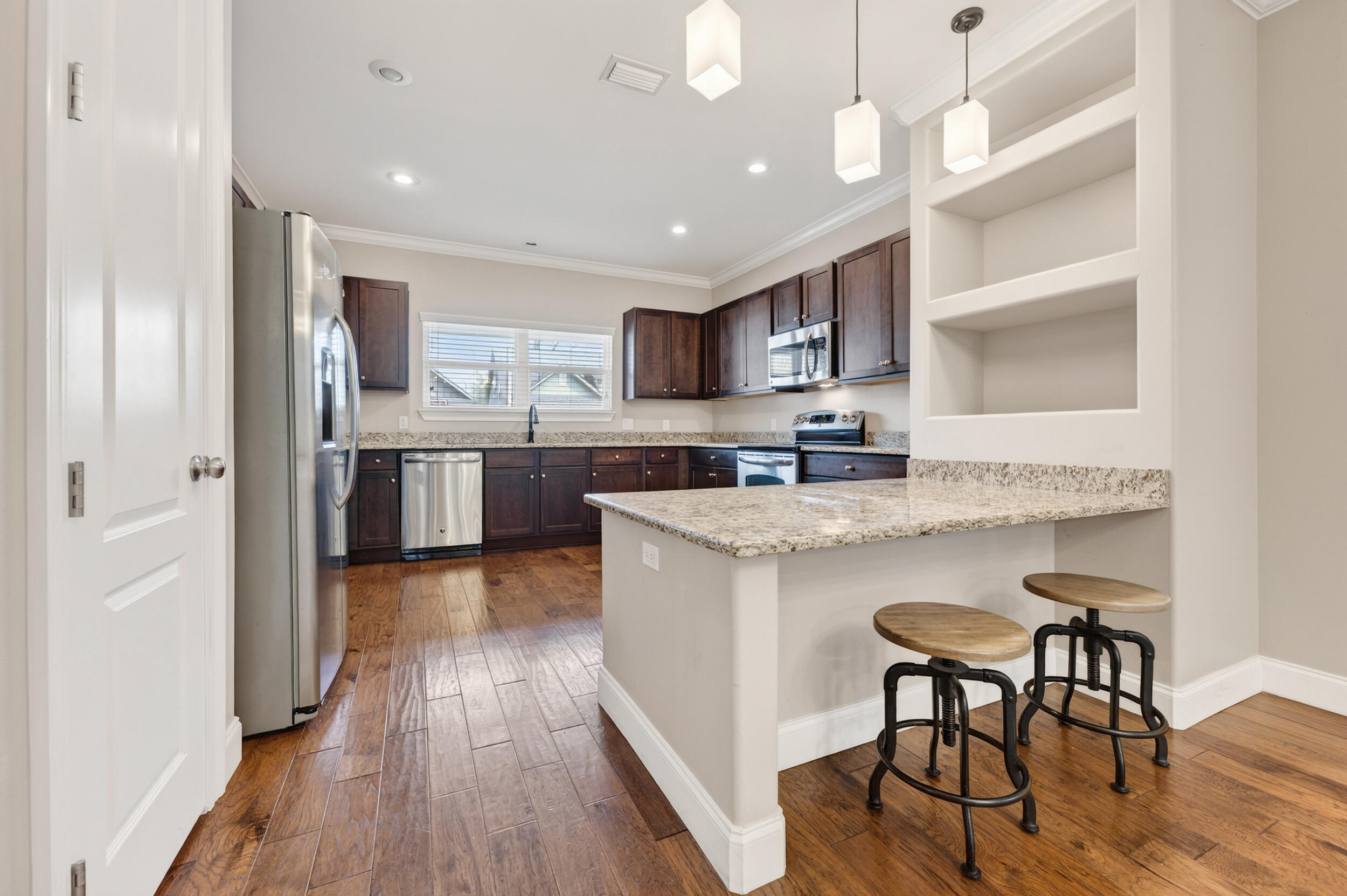 106 Arrowhead Way Niceville, FL 32578 - Photo 11 of 39 a kitchen with stainless steel appliances granite countertop a table chairs refrigerator and sink