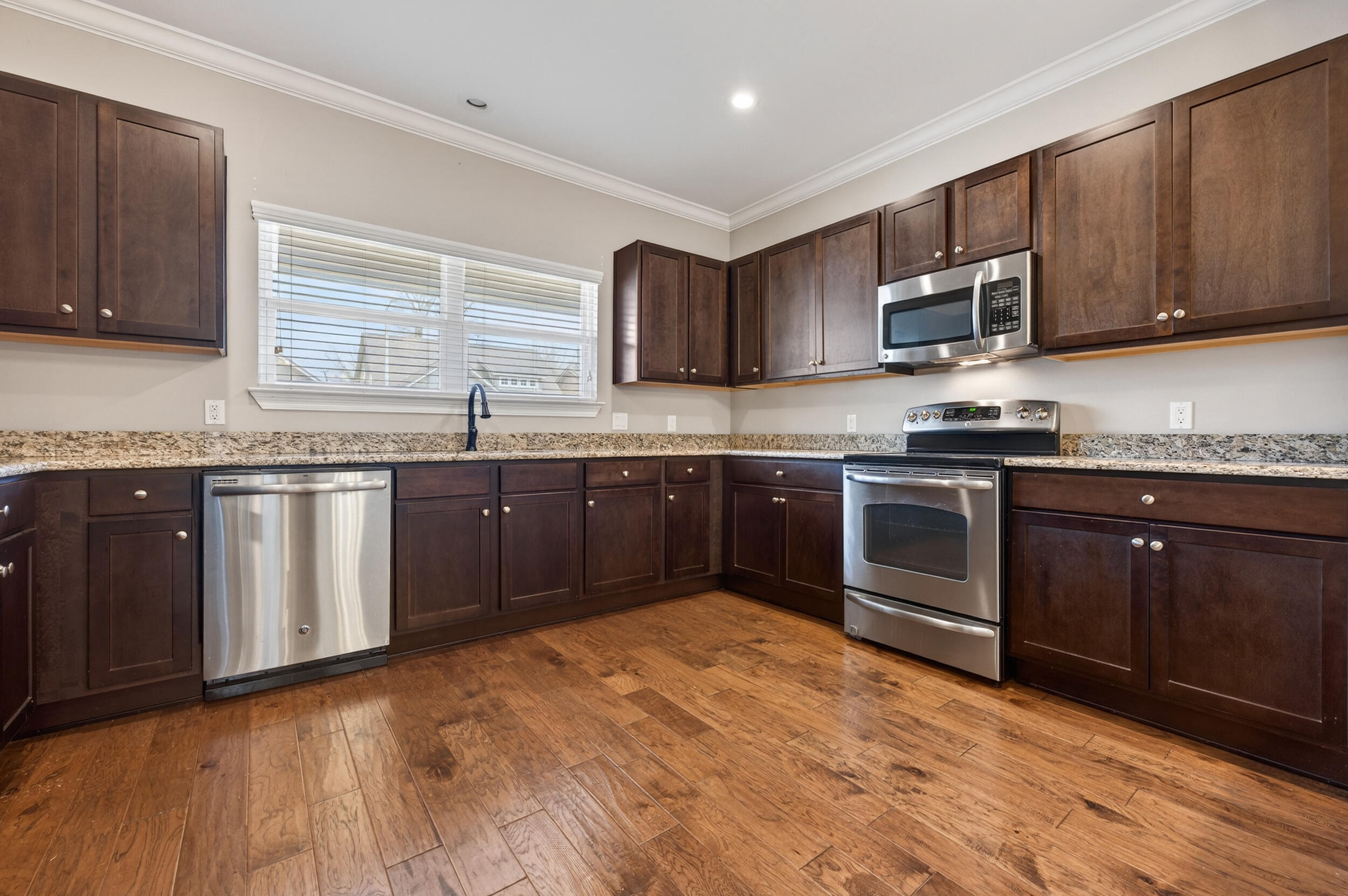 106 Arrowhead Way Niceville, FL 32578 - Photo 12 of 39 a kitchen with stainless steel appliances granite countertop a stove top oven a sink dishwasher and a microwave