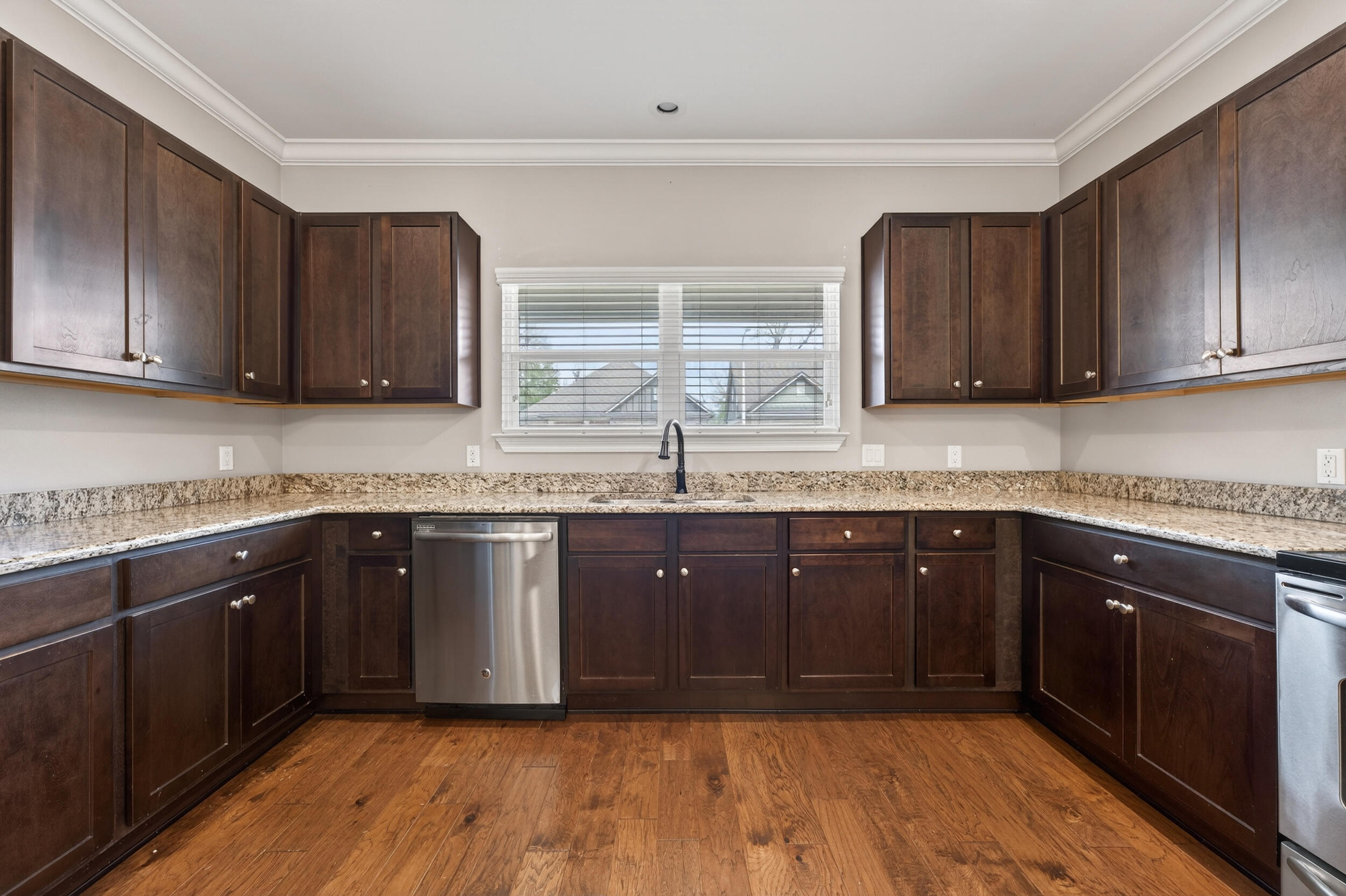106 Arrowhead Way Niceville, FL 32578 - Photo 16 of 39 a kitchen with granite countertop wooden cabinets a sink and dishwasher