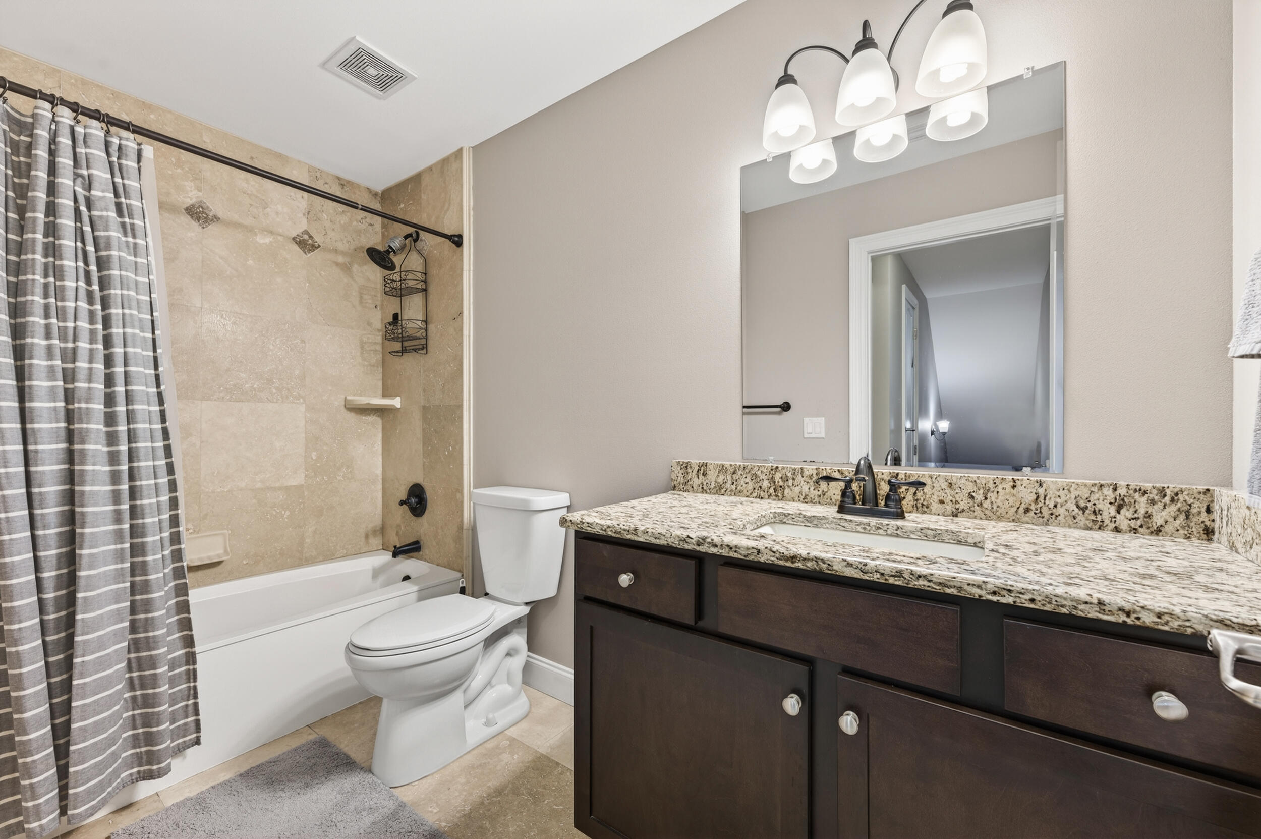 106 Arrowhead Way Niceville, FL 32578 - Photo 31 of 39 a bathroom with a granite countertop sink toilet a shower and a mirror