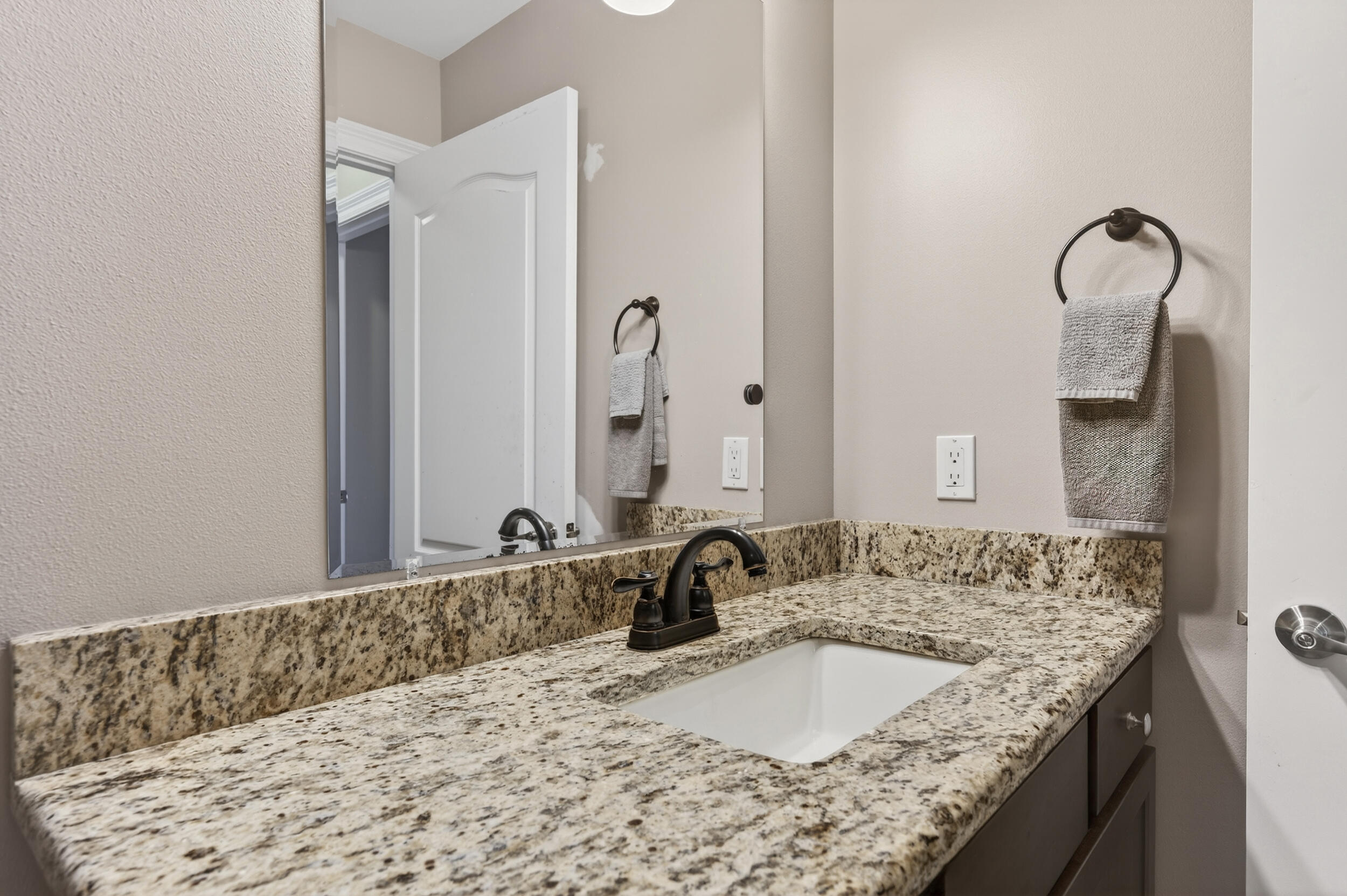 106 Arrowhead Way Niceville, FL 32578 - Photo 32 of 39 a bathroom with a granite countertop sink and a mirror