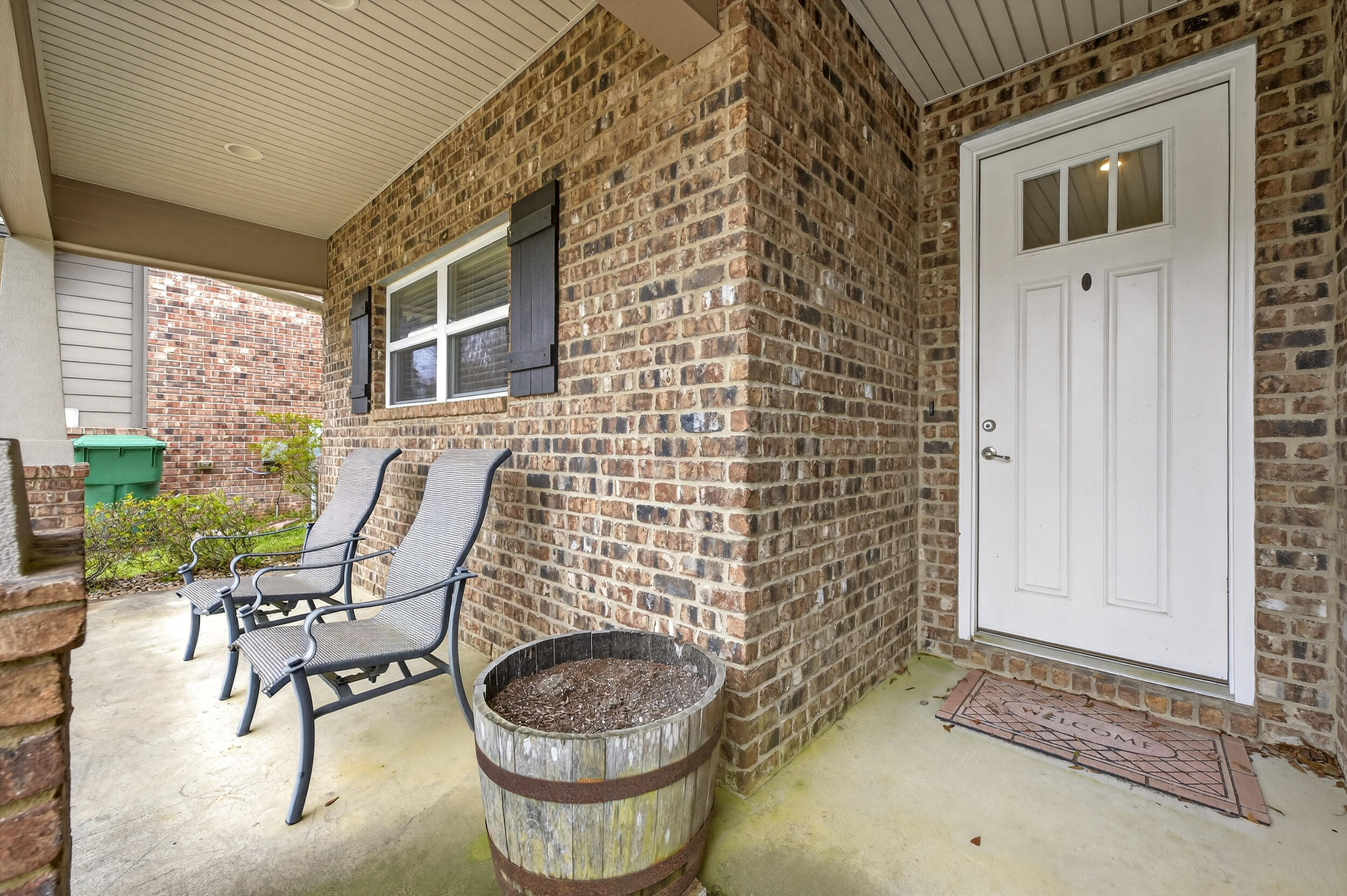106 Arrowhead Way Niceville, FL 32578 - Photo 5 of 39 a balcony with chairs and a potted plant