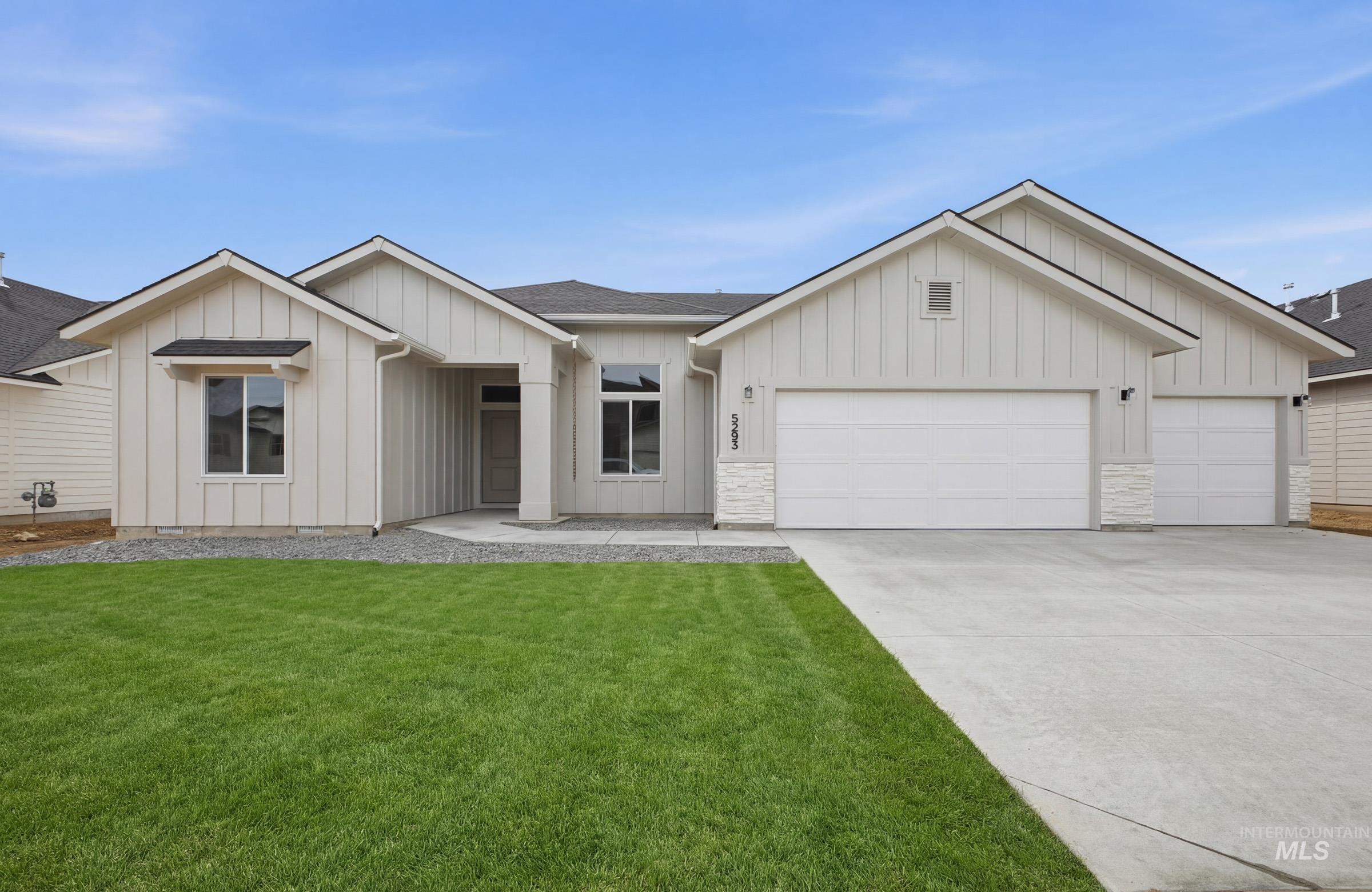 Modern inspired farmhouse with board and batten siding, an attached garage, roof with shingles, concrete driveway, and a front yard