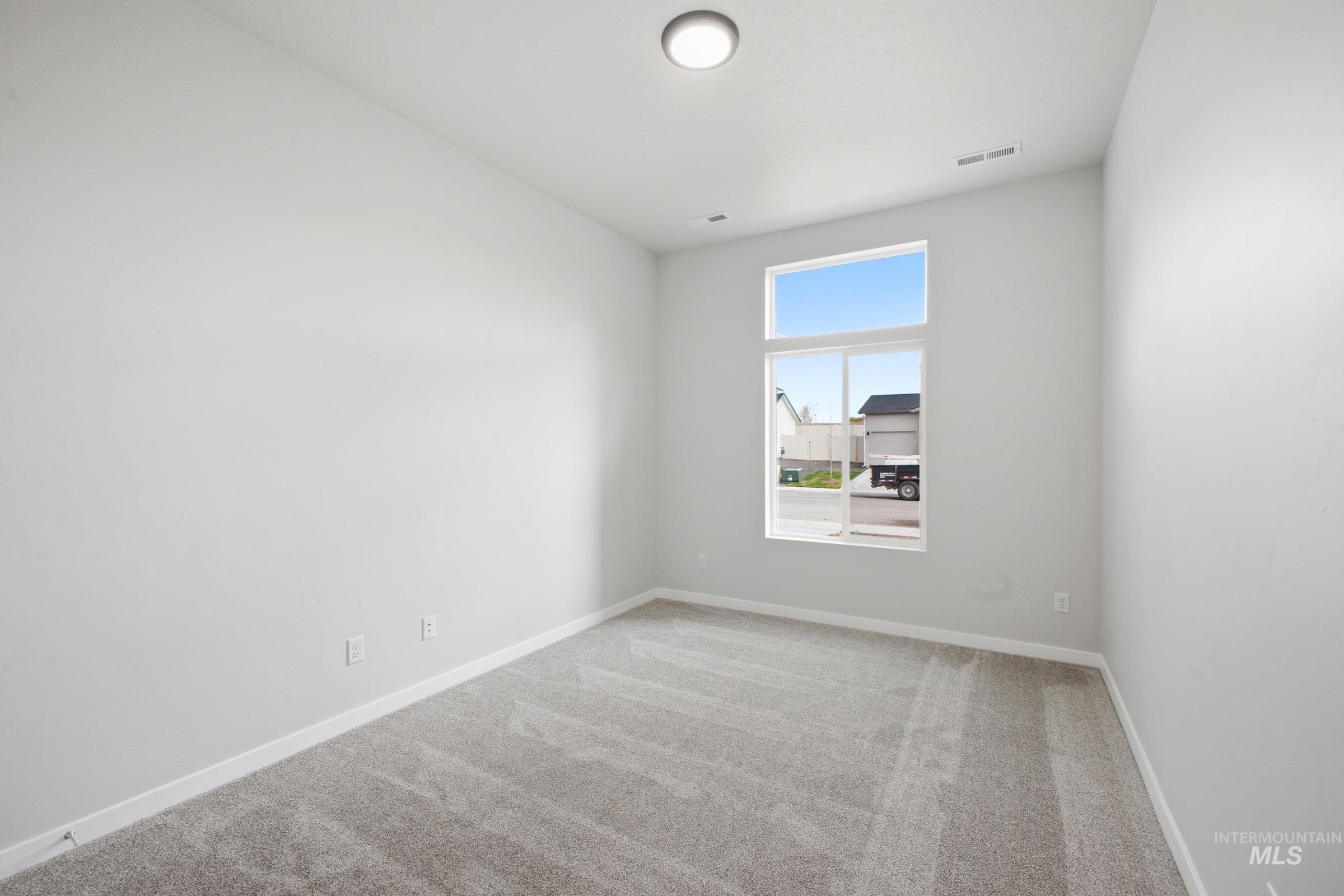 5293 South Memory Avenue Meridian, ID 83642 - Photo 13 of 24 Unfurnished room with light carpet and baseboards