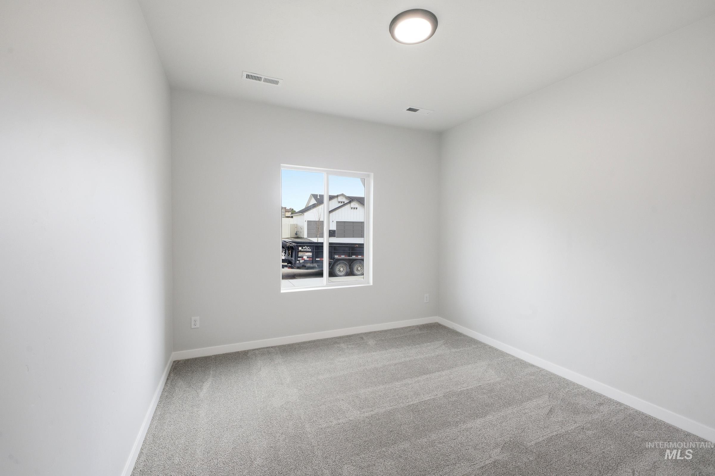 5293 South Memory Avenue Meridian, ID 83642 - Photo 14 of 24 Spare room featuring light carpet and baseboards