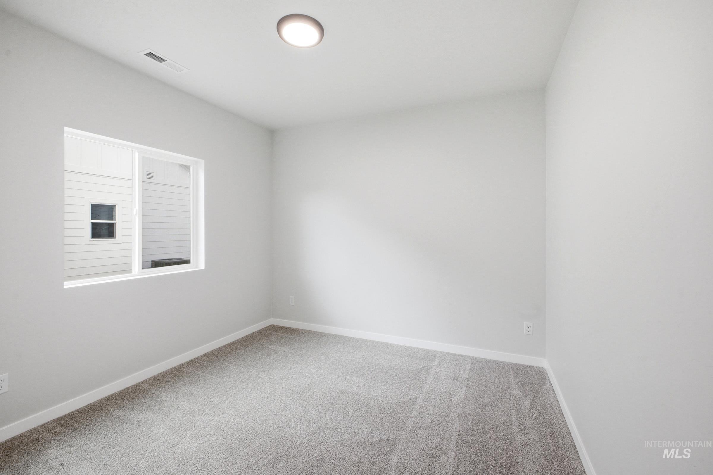 5293 South Memory Avenue Meridian, ID 83642 - Photo 15 of 24 Unfurnished room featuring light colored carpet and baseboards