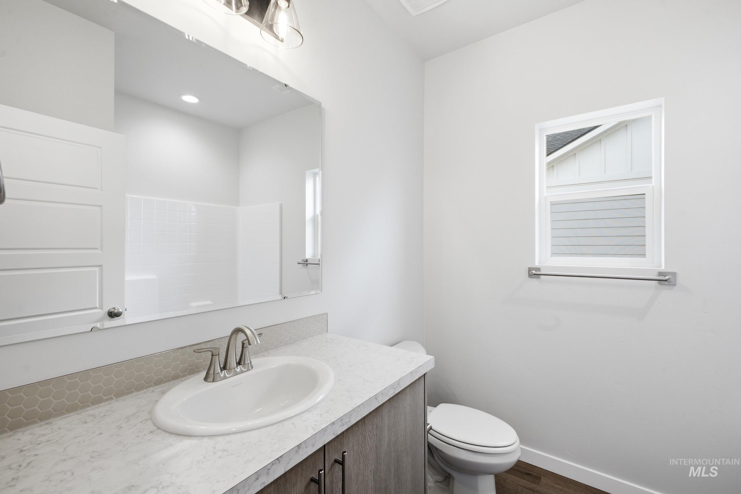 5293 South Memory Avenue Meridian, ID 83642 - Photo 16 of 24 Full bathroom with vanity, dark wood-style flooring, and a shower
