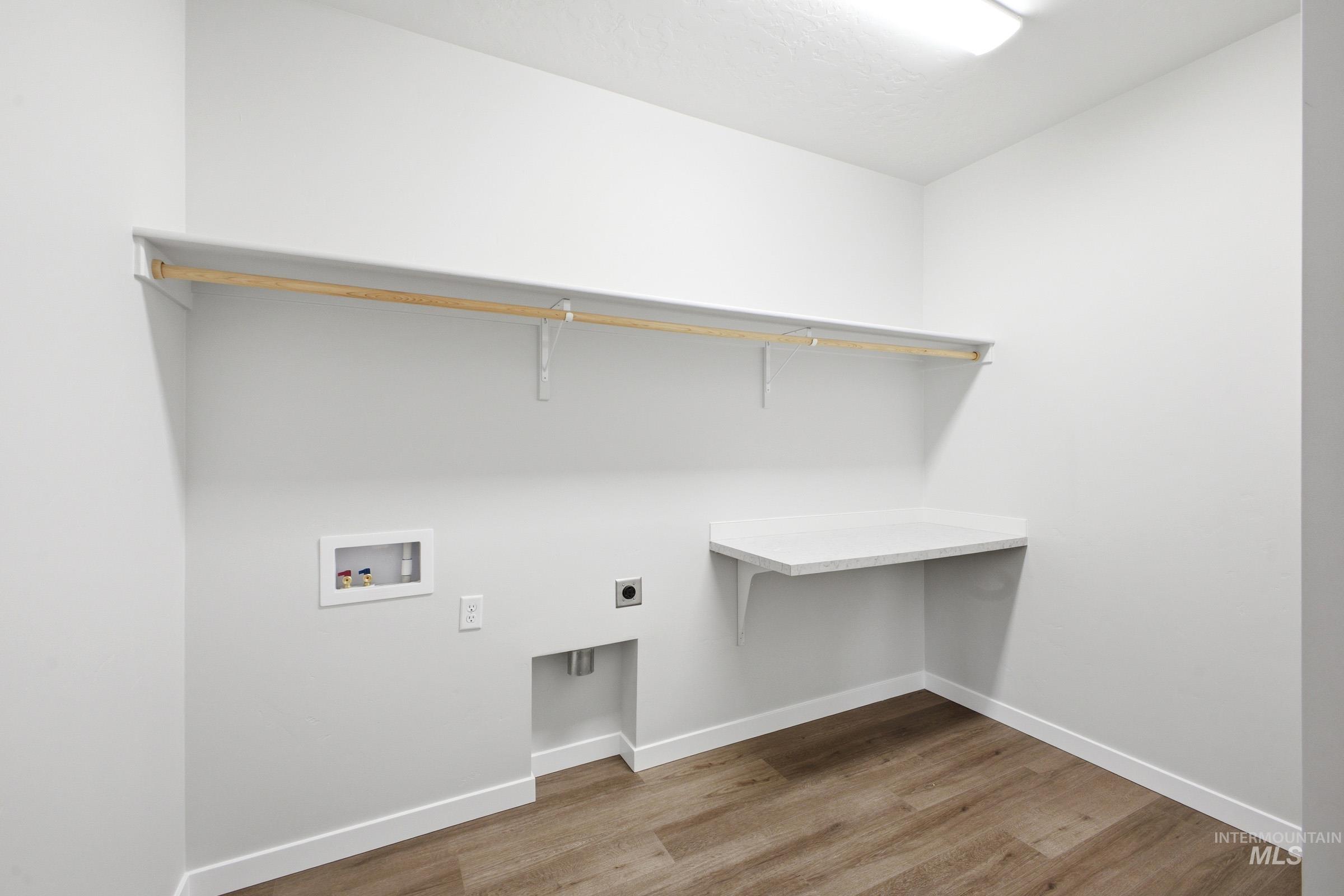 5293 South Memory Avenue Meridian, ID 83642 - Photo 18 of 24 Laundry room with light wood-style flooring, electric dryer hookup, and washer hookup