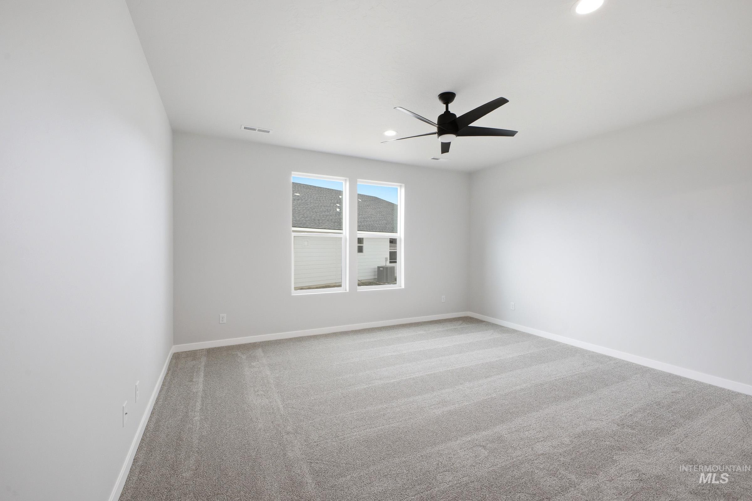 5293 South Memory Avenue Meridian, ID 83642 - Photo 19 of 24 Empty room with light colored carpet, a ceiling fan, and recessed lighting
