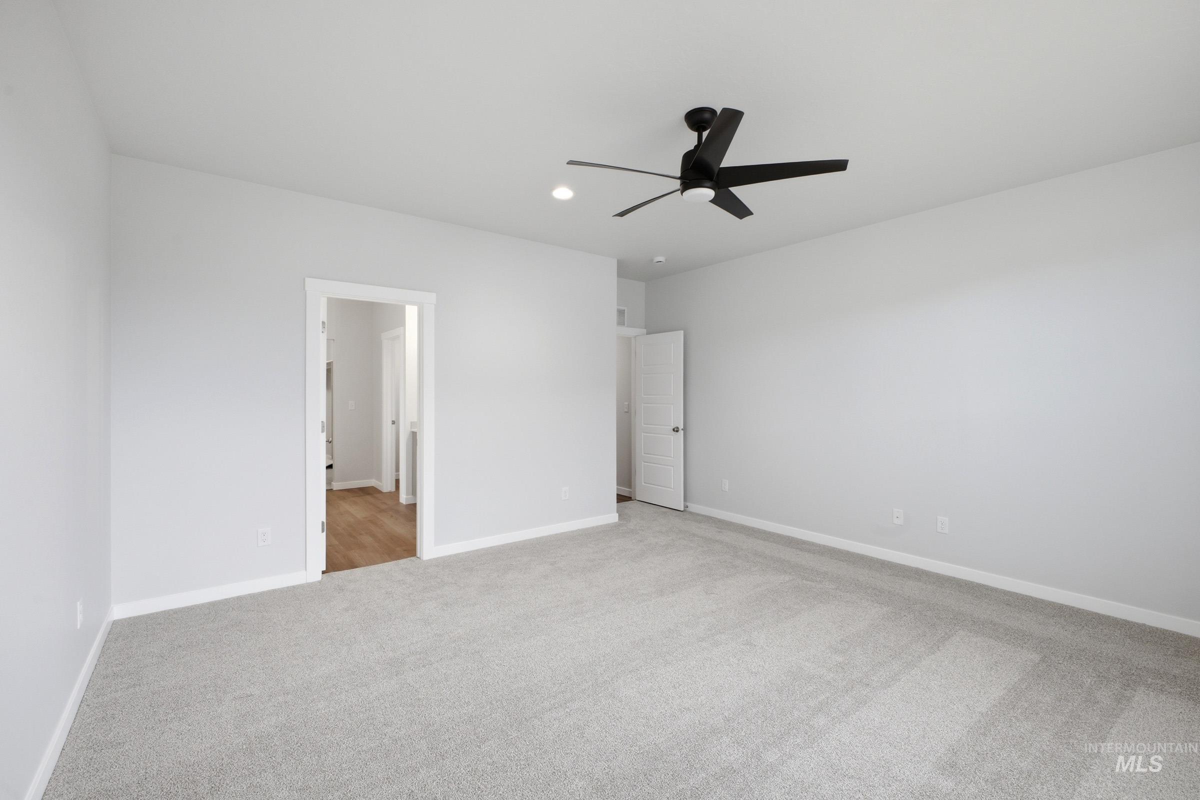 5293 South Memory Avenue Meridian, ID 83642 - Photo 20 of 24 Unfurnished bedroom featuring light carpet, a ceiling fan, and recessed lighting