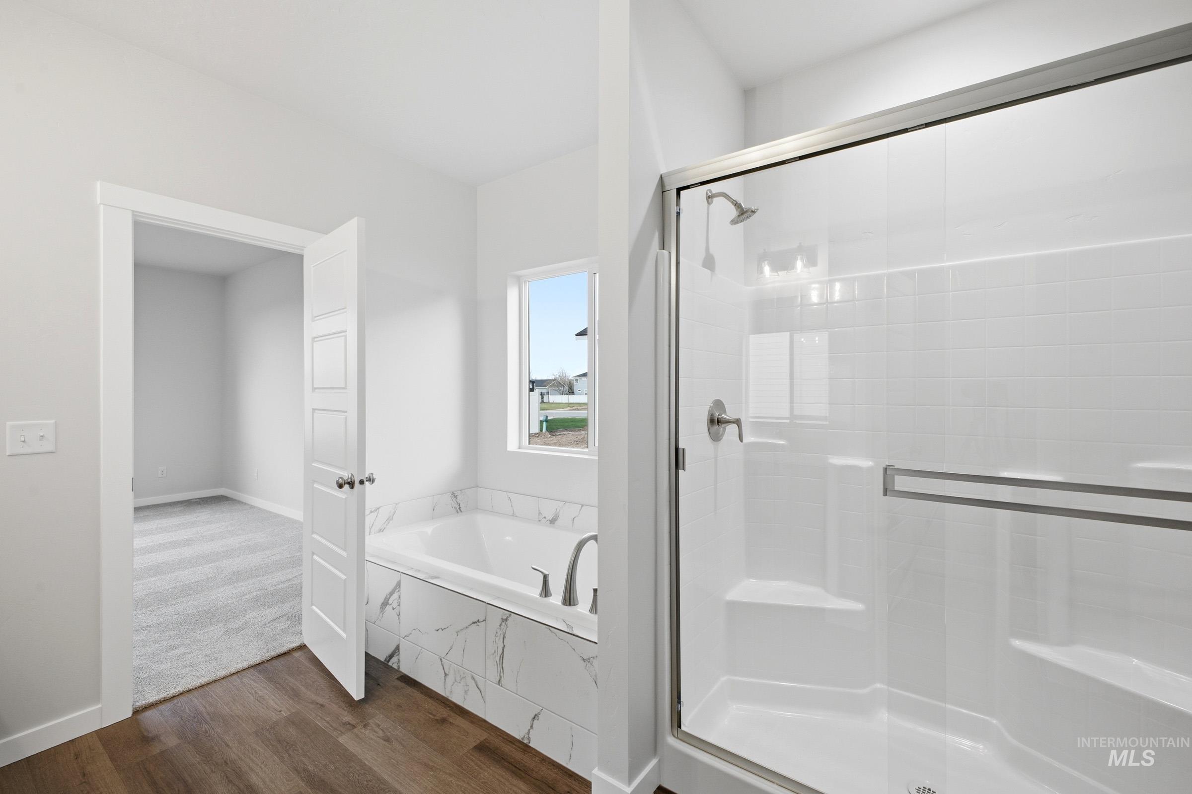 5293 South Memory Avenue Meridian, ID 83642 - Photo 22 of 24 Full bath with a garden tub, dark wood finished floors, and a shower stall