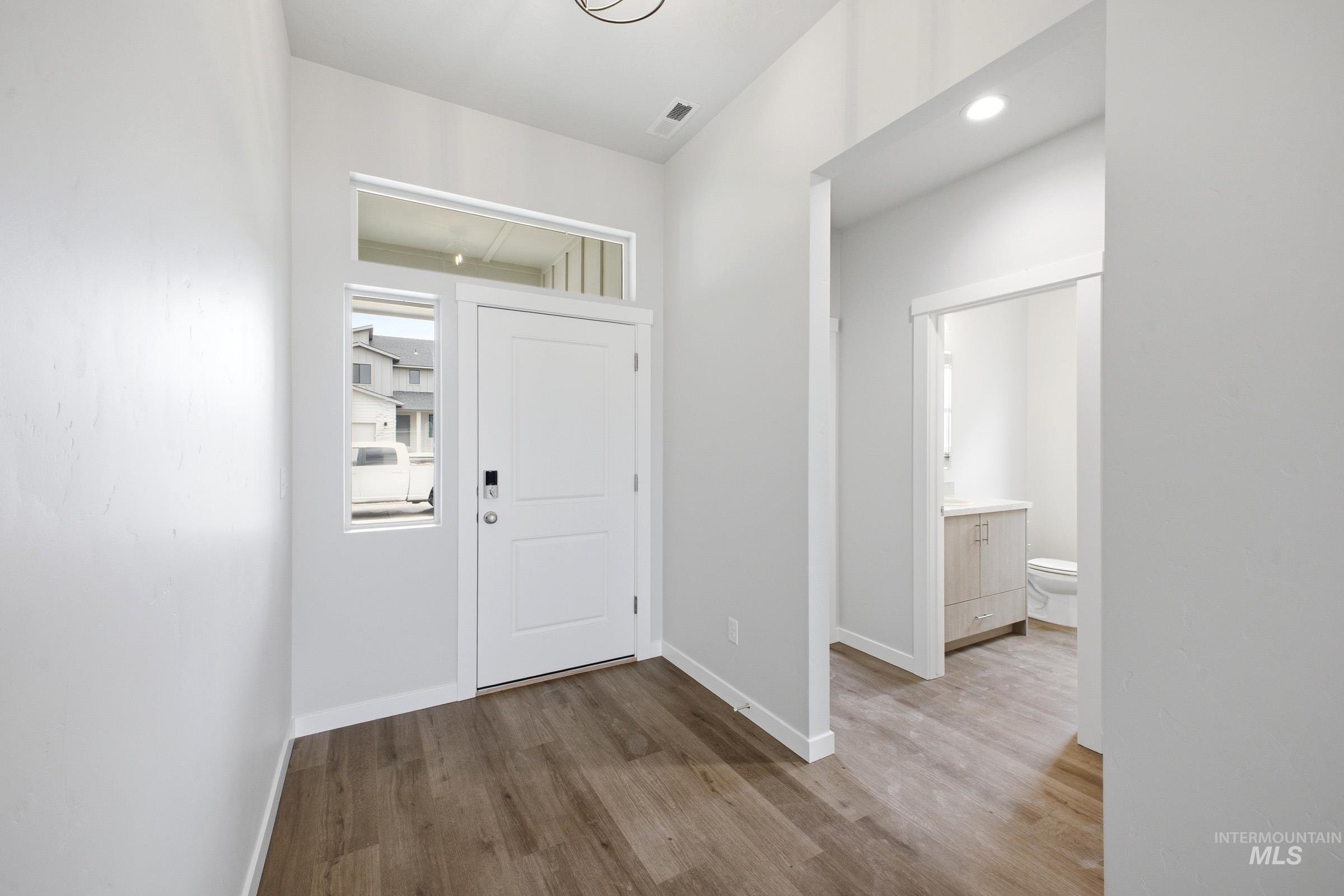 5293 South Memory Avenue Meridian, ID 83642 - Photo 3 of 24 Foyer entrance with light wood finished floors and baseboards