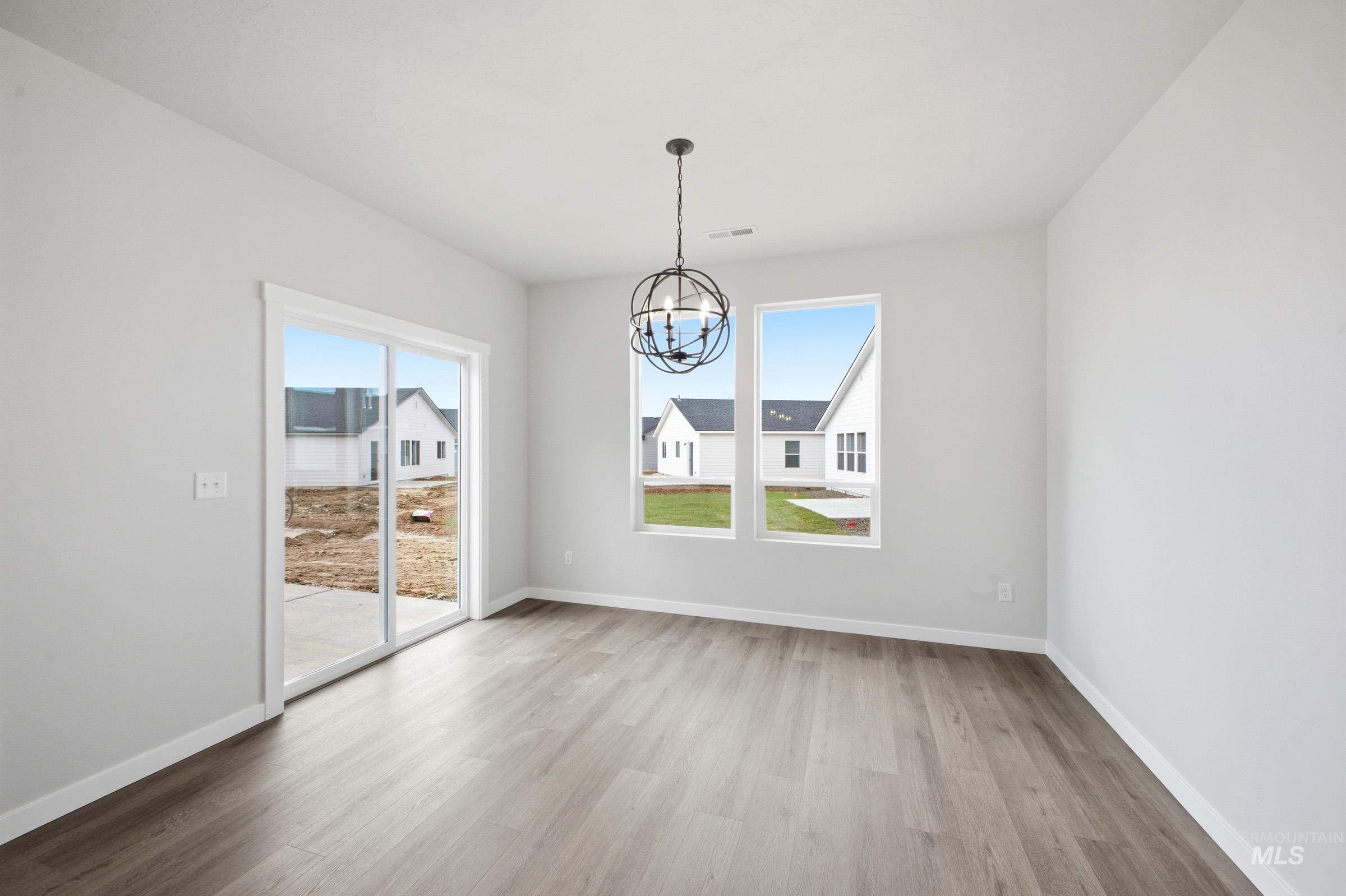 5293 South Memory Avenue Meridian, ID 83642 - Photo 9 of 24 Unfurnished dining area with suspended lighting and light wood finished floors