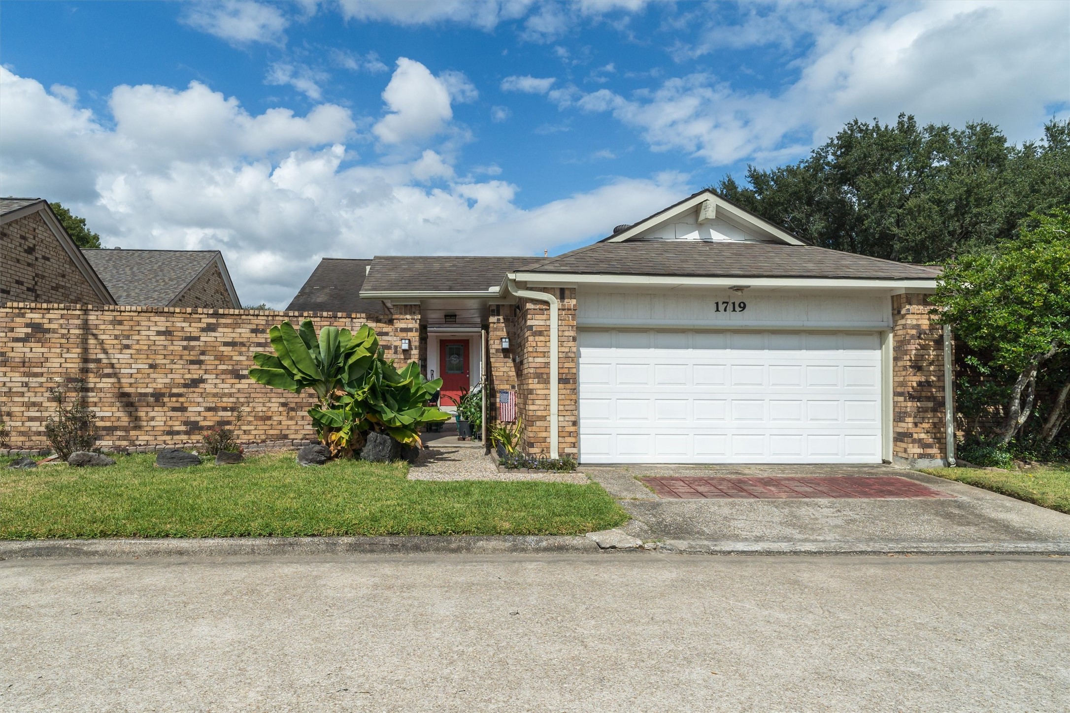 1719 Sullins Way Houston, TX 77058 - Photo 1 of 27 a front view of a house with a yard and garage
