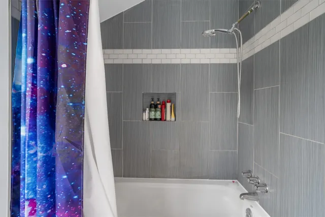 a bathroom with a bathtub and shower