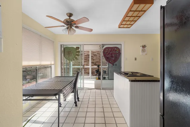 a view of a hallway with wooden floor and a chandelier