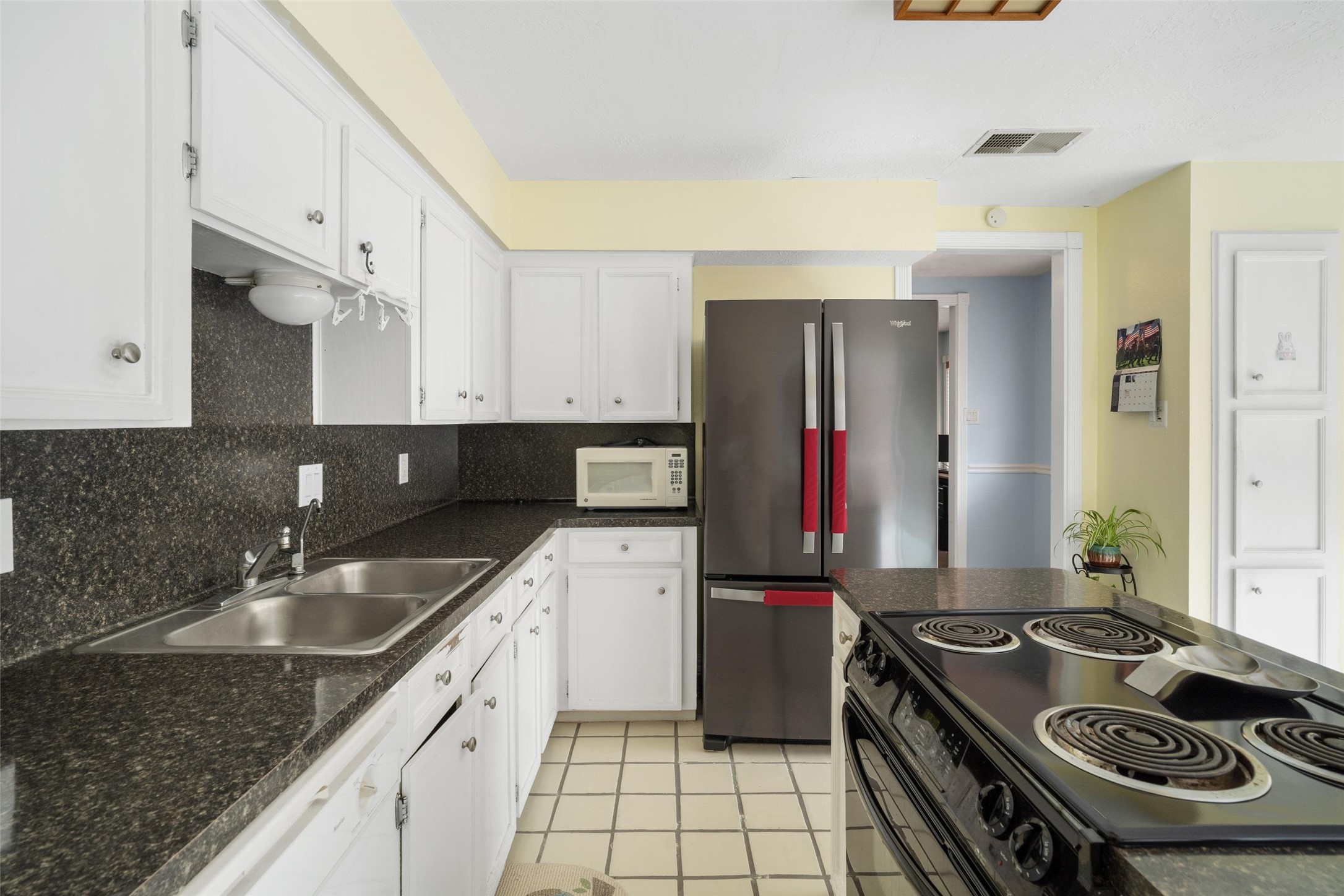 1719 Sullins Way Houston, TX 77058 - Photo 10 of 27 a kitchen with a sink stove and refrigerator