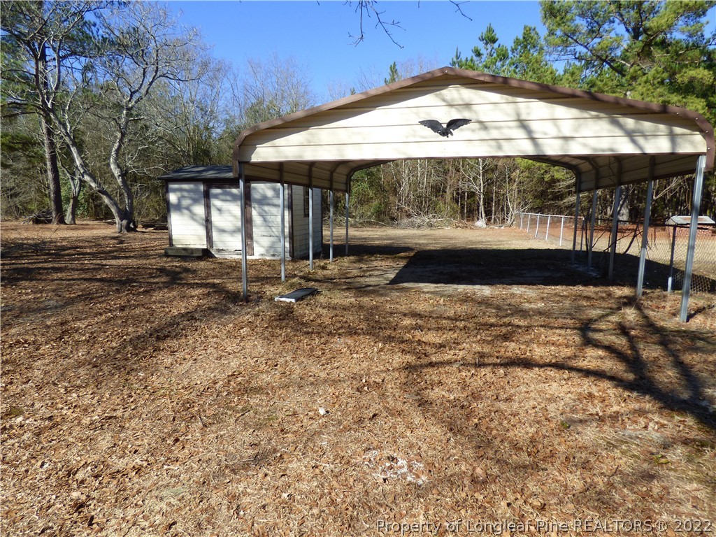 6690 Turnpike Road Raeford, NC 28376 - Photo 11 of 12 a view of a house with a yard