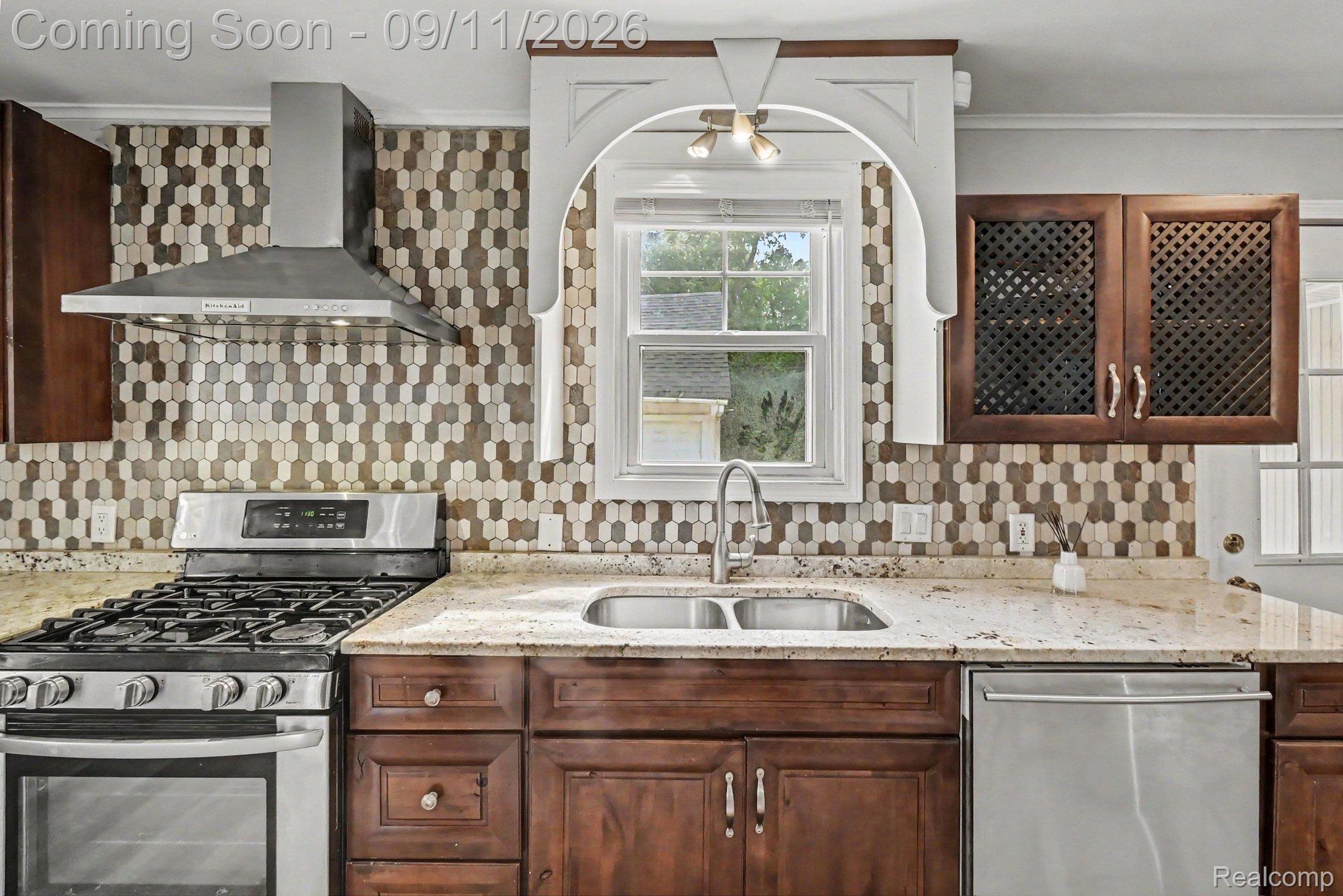 409 Fleming Street Howell, MI 48843 - Photo 6 of 25 Stainless steel range with a coordinating range hood