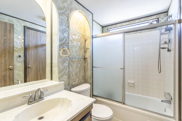a bathroom with a sink toilet and shower