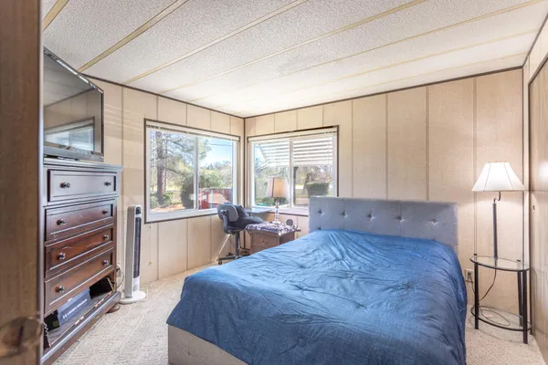 a large bedroom with a large bed and furniture