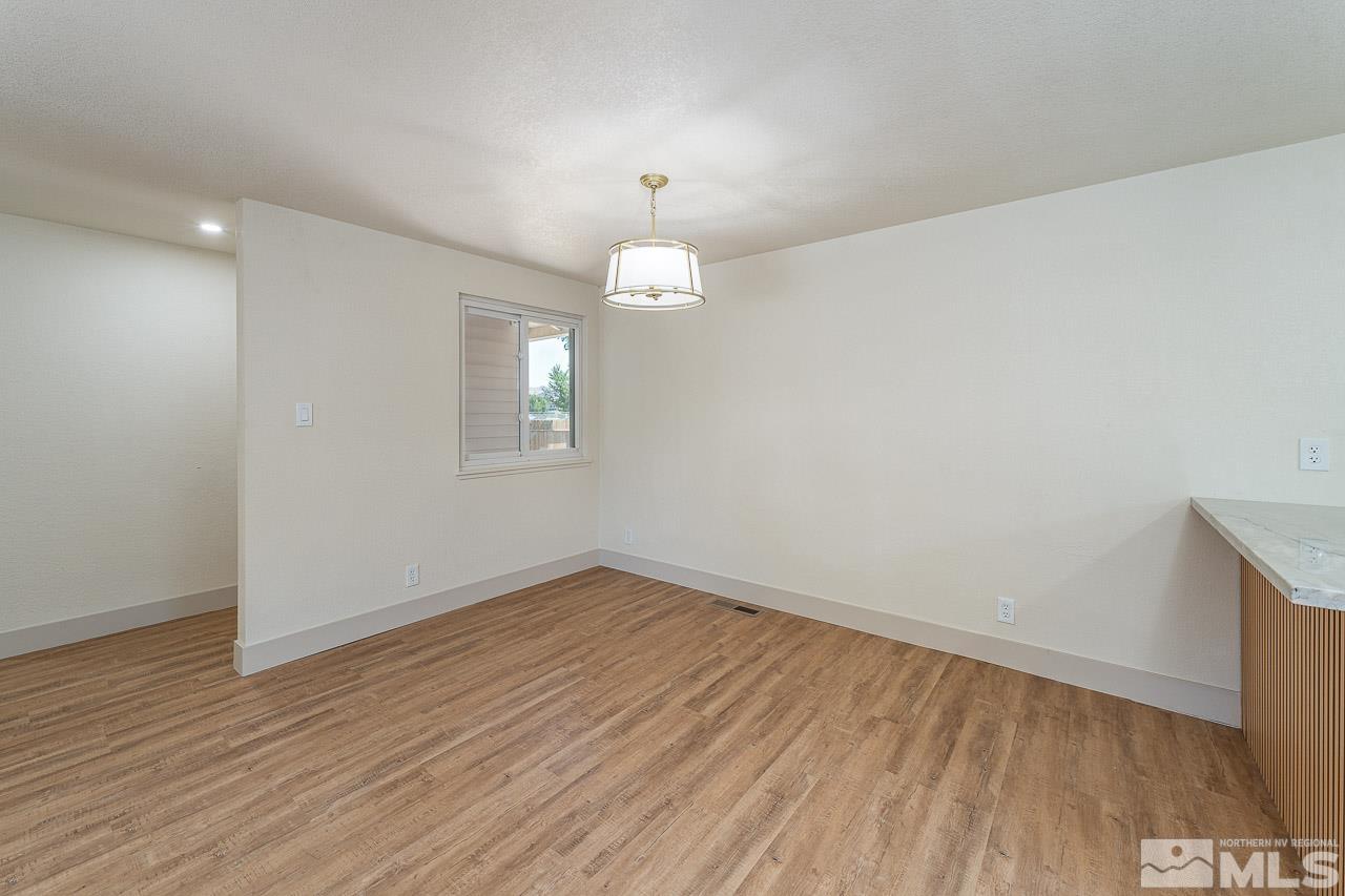 2857 Jake Street Reno, NV 89502 - Photo 8 of 22 wooden floor in an empty room with a window
