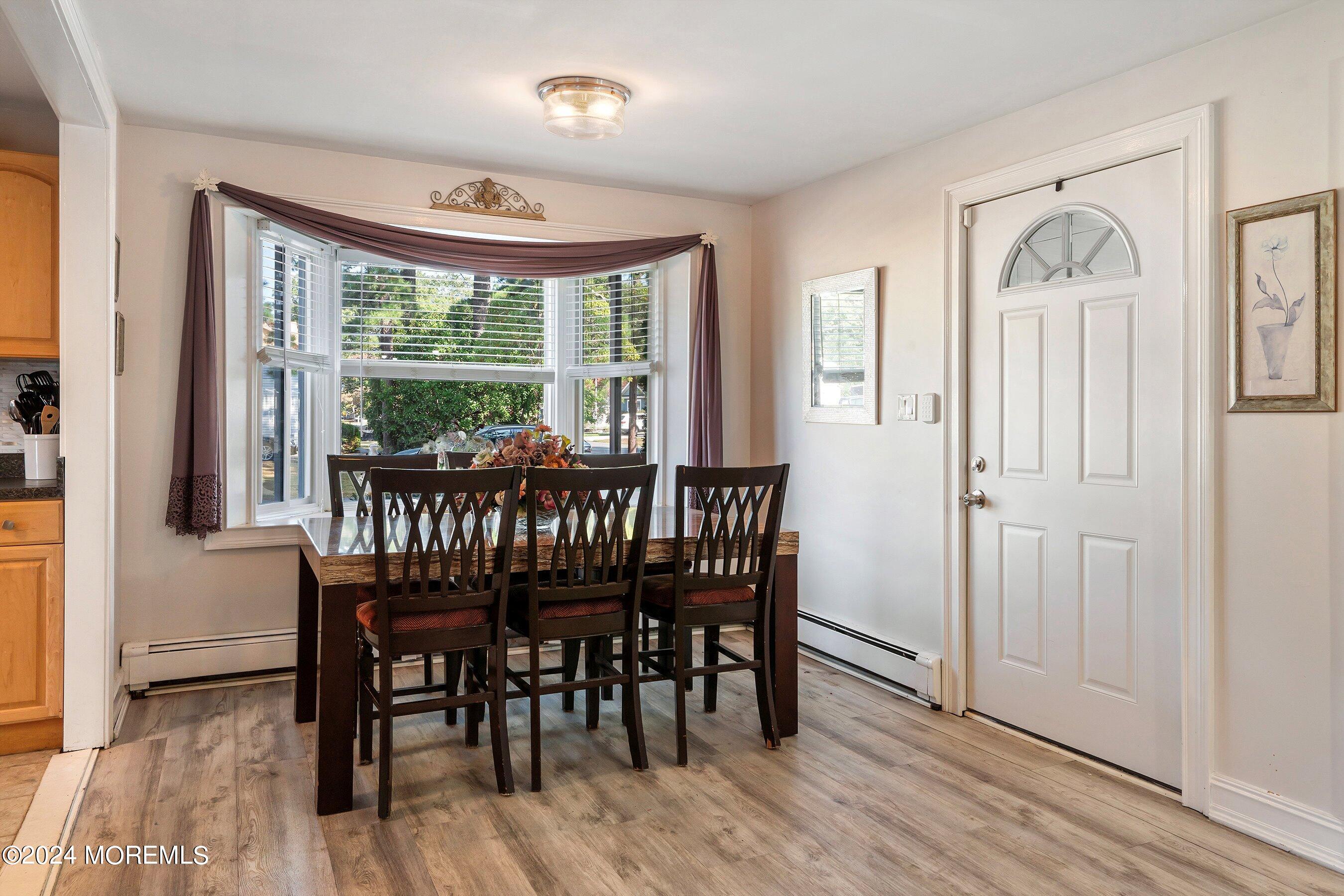 1507 Whitcomb Road Forked River, NJ 08731 - Photo 4 of 30 a view of a dining room with furniture window and wooden floor