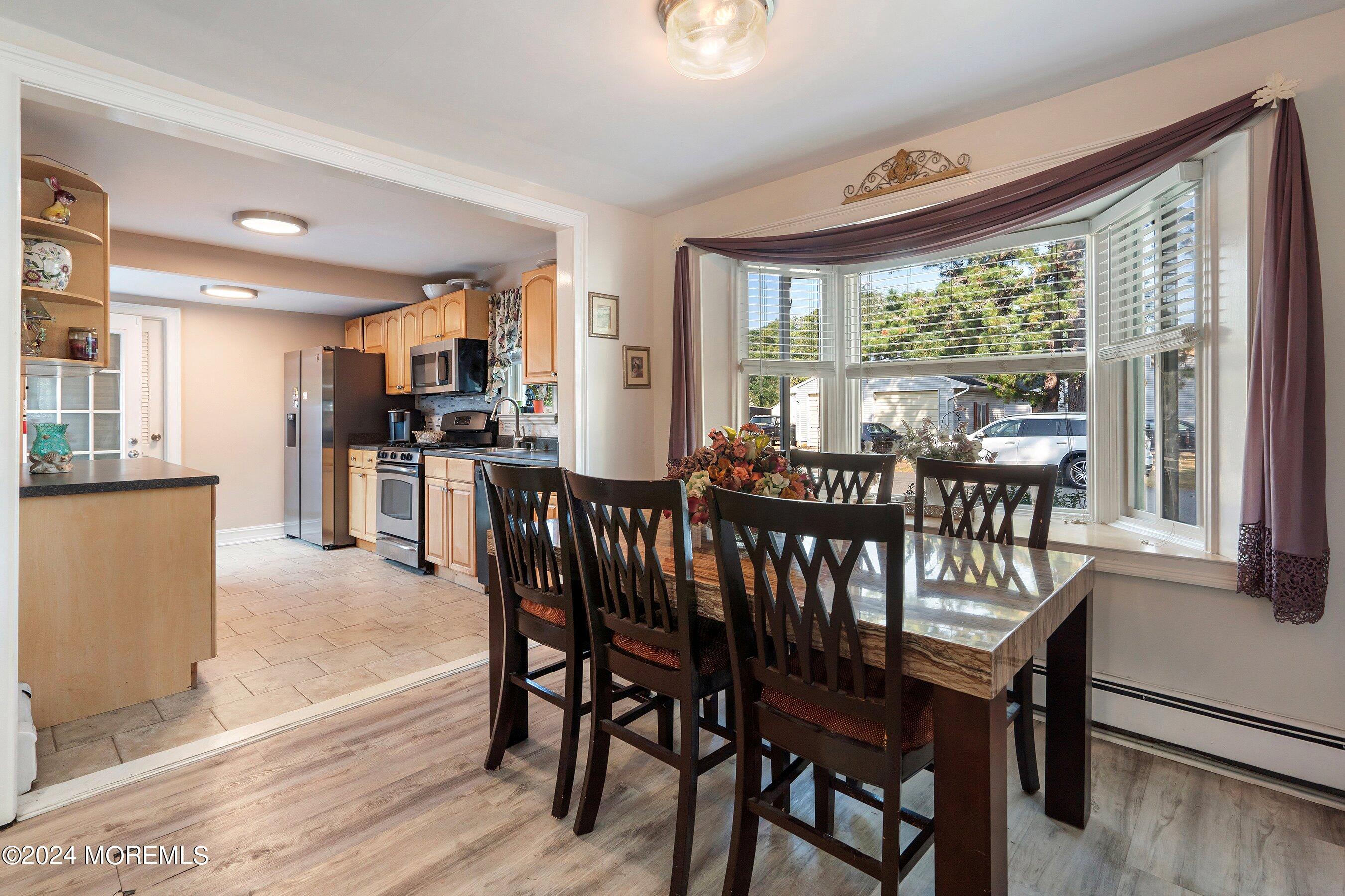 1507 Whitcomb Road Forked River, NJ 08731 - Photo 5 of 30 a view of a dining room with furniture window and wooden floor