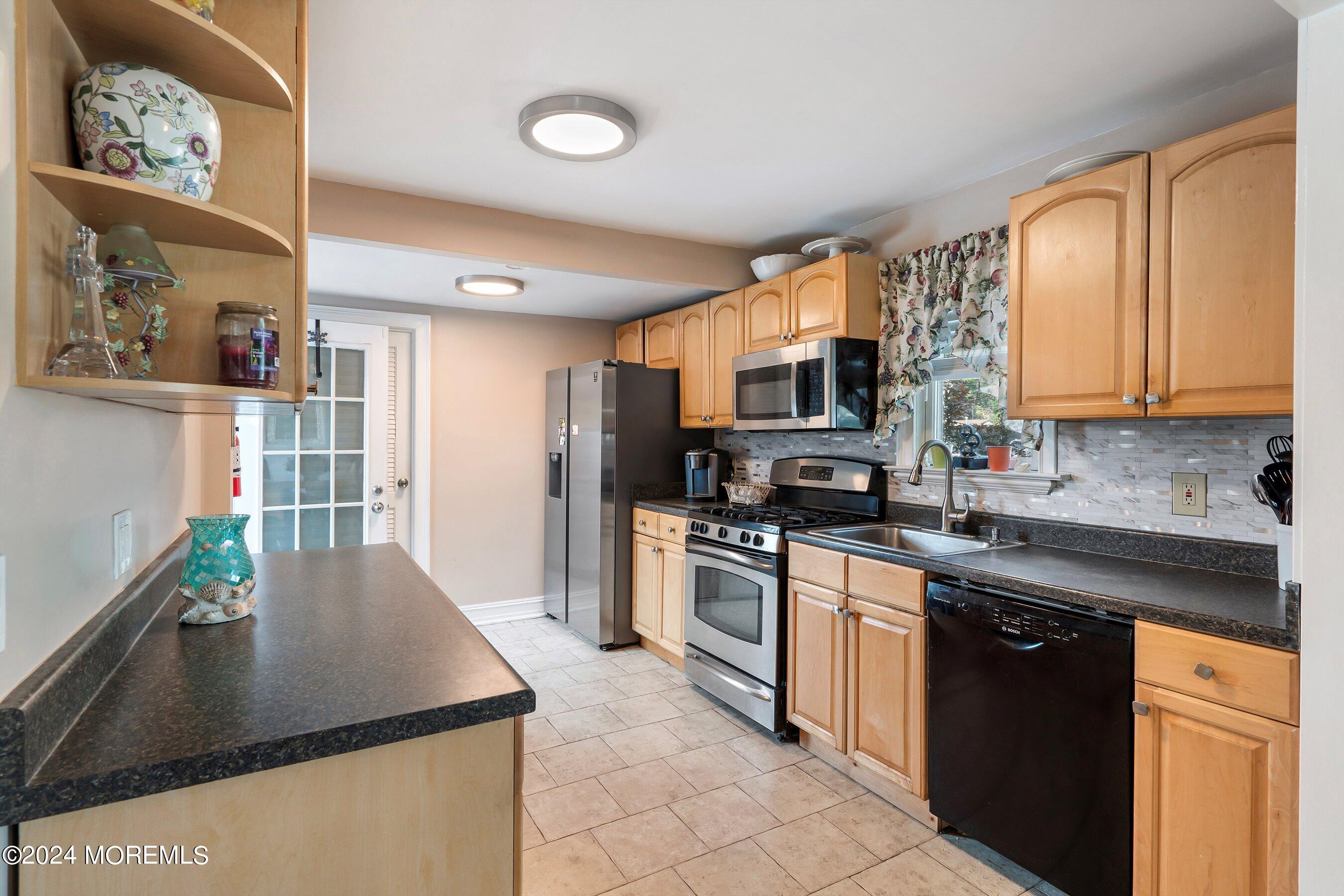 1507 Whitcomb Road Forked River, NJ 08731 - Photo 6 of 30 a kitchen with stainless steel appliances granite countertop a stove a sink dishwasher a refrigerator and a microwave oven with wooden floor
