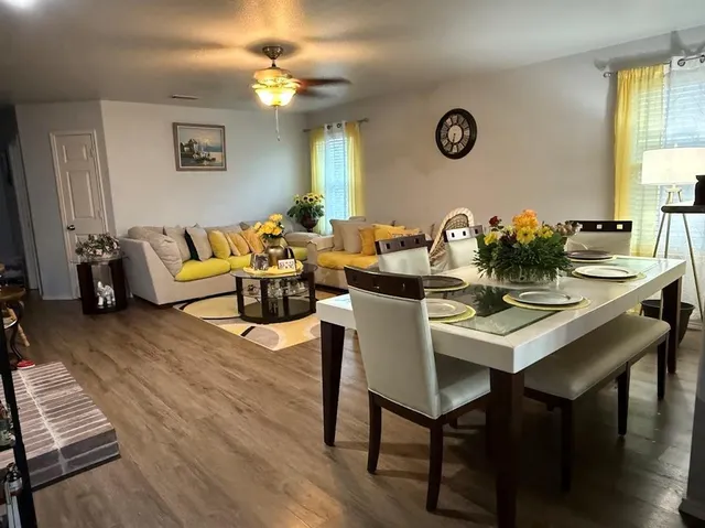 a living room with furniture a window and a table