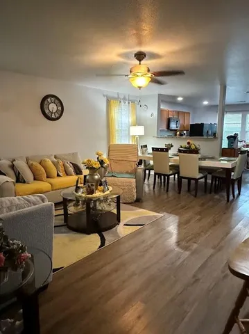a living room with lots of furniture and a wooden floor