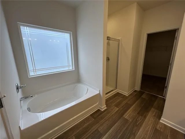 a bathroom with a tub and a shower