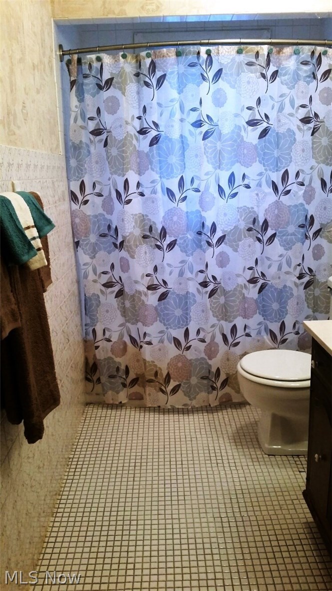 13271 McCracken Road Cleveland, OH 44125 - Photo 12 of 24 What a cute bathroom! Original tile on floor, new toilet seat, great shower and tub. Neutral and charming