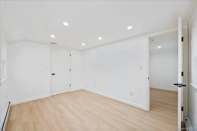 a kitchen with a refrigerator sink and white cabinets