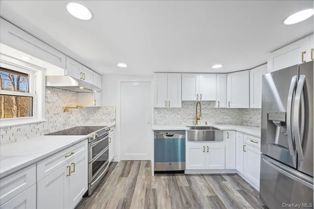 a kitchen with stainless steel appliances granite countertop a sink stove and refrigerator