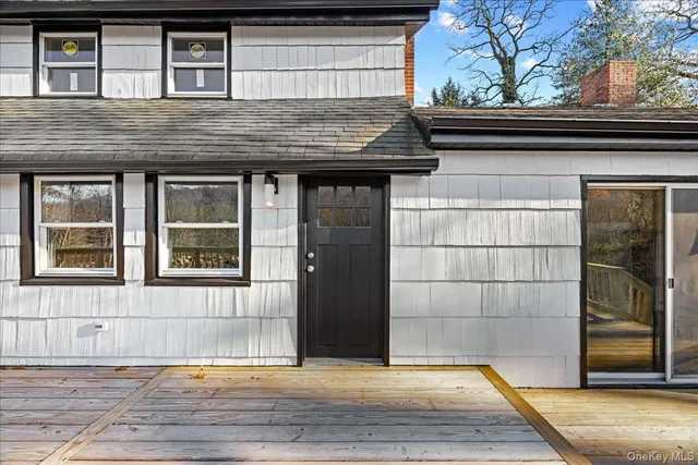 a view of a house with snow on the road