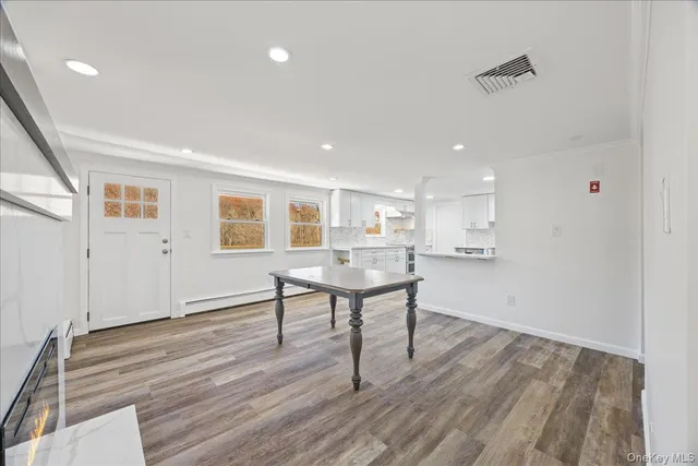 a view of a livingroom with furniture and wooden floor