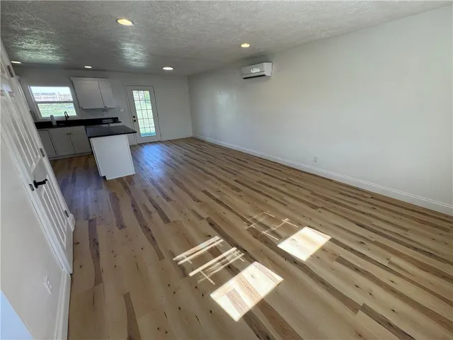 a view of an empty room and wooden floor