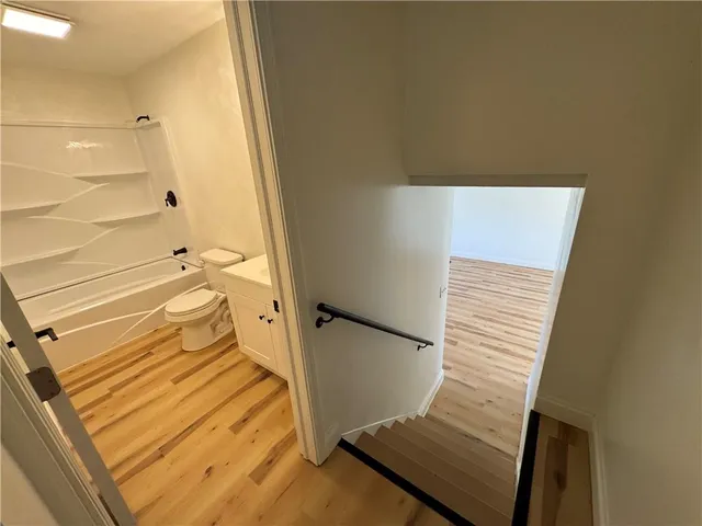 a bathroom with a toilet and a shower